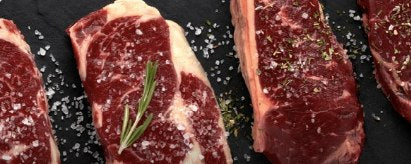 Grass-fed steaks seasoned on slate