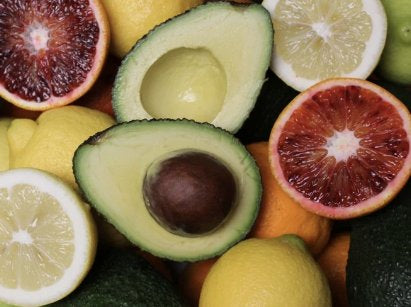 Halved blood oranges, lemons and avocados